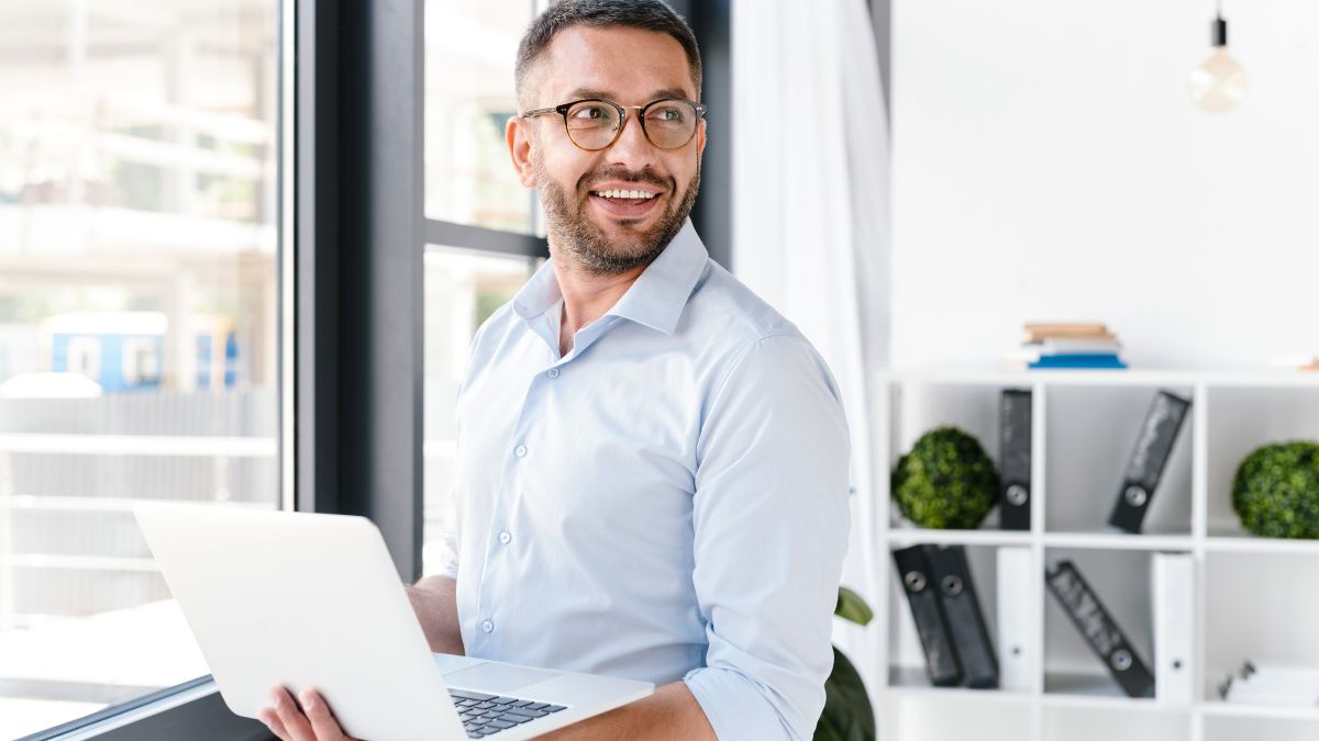 Man standing with laptop